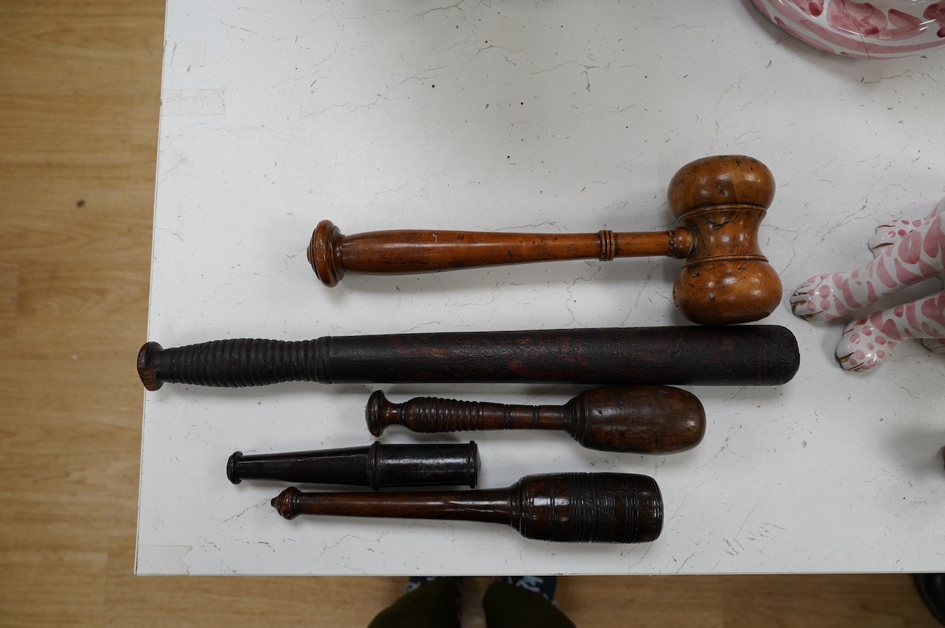 A large fruitwood gavel, a truncheon, a lead-weighted cosh and two others, longest 42cm. Condition - fair